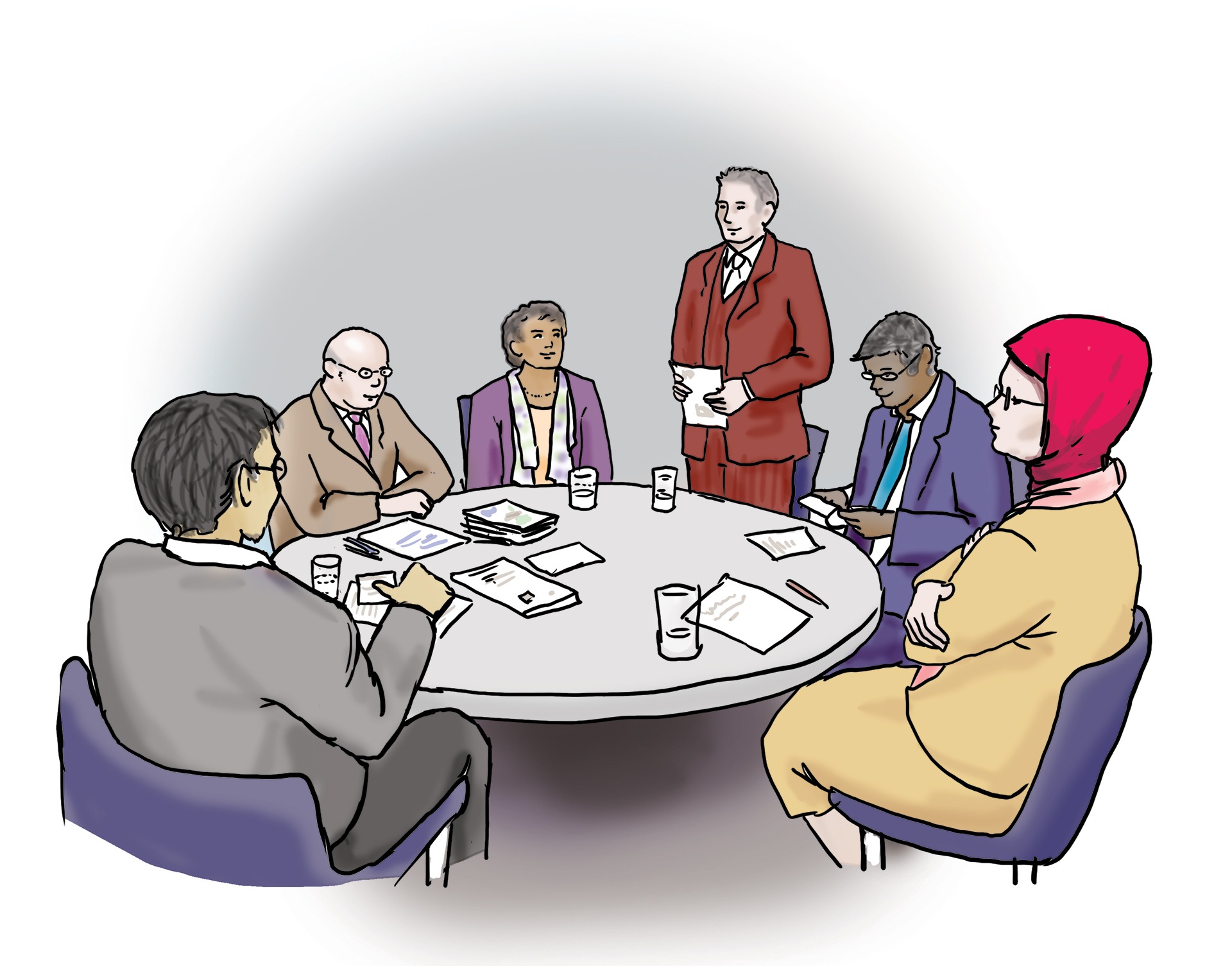 Das Bild zeigt eine Gruppe von Menschen. Sie sitzen an einem runden Tisch.